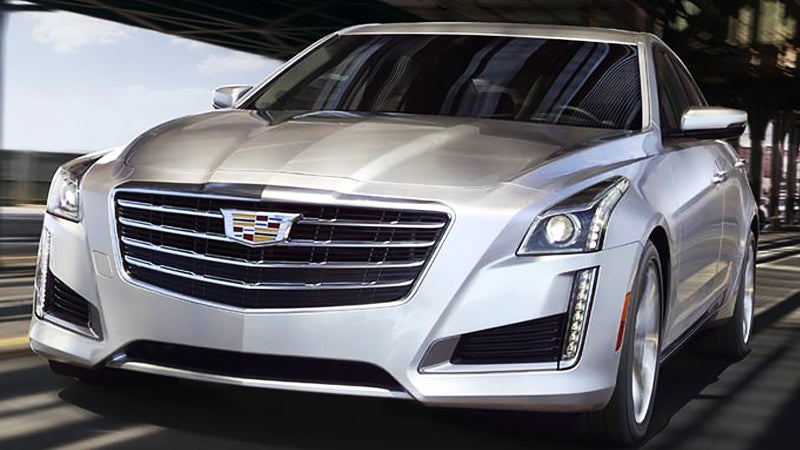 The front view of a silver Cadillac, showcasing its sleek design and distinctive grille.