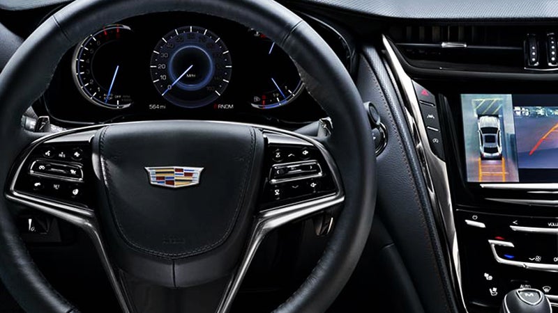 Interior view of a Cadillac vehicle showcasing the dashboard and steering wheel
