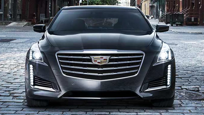 Front view of a black Cadillac SUV showcasing its sleek design and distinctive grille.