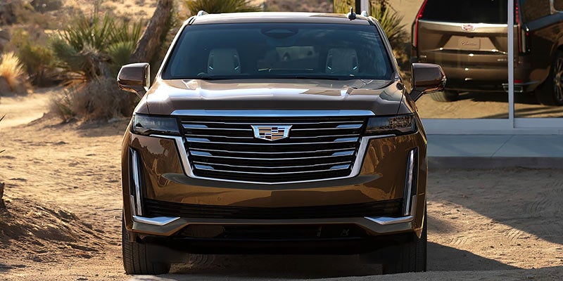 Front view of a brown Cadillac SUV.