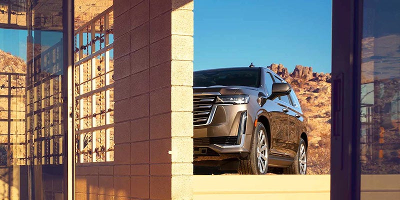 Rear view of a black Cadillac SUV parked