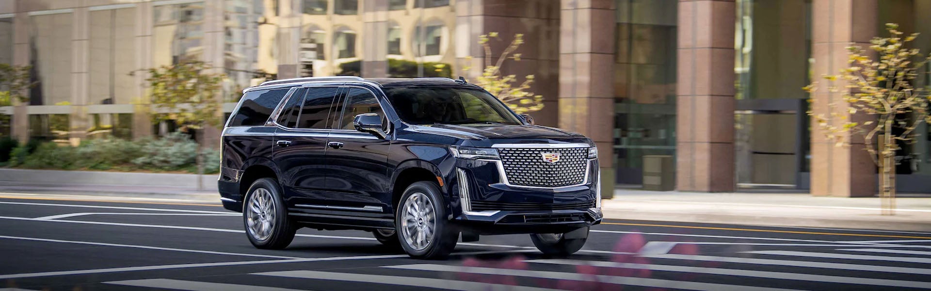 A 2020 Cadillac Escalade driving down a city street