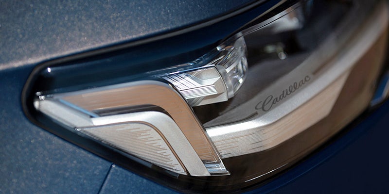 Close-up of a blue car's headlight.